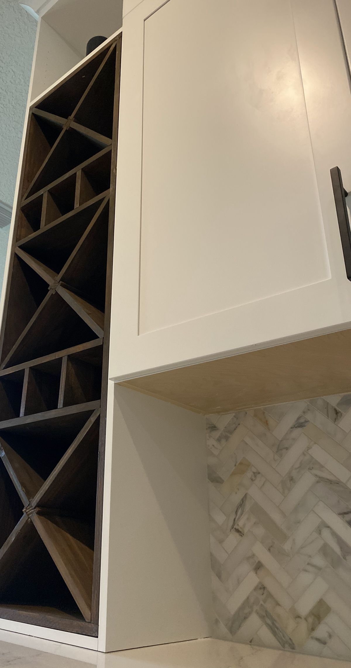 Custom X wine rack built into white cabinetry