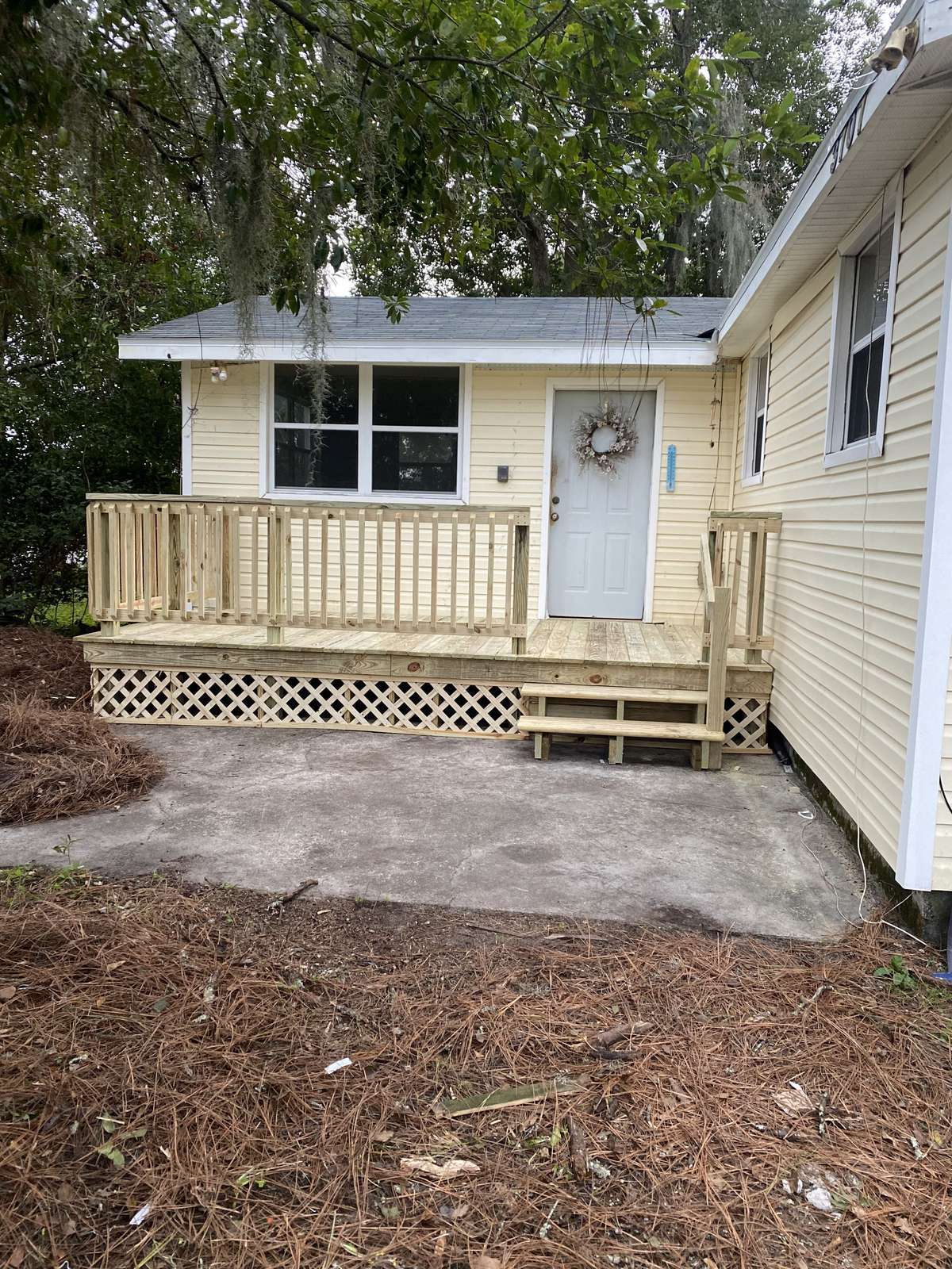 New front porch with railings and lattice skirting