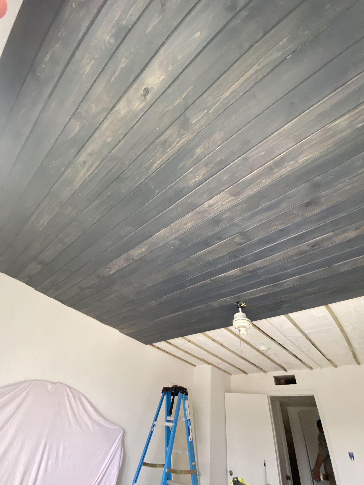 Finished gray wood plank ceiling