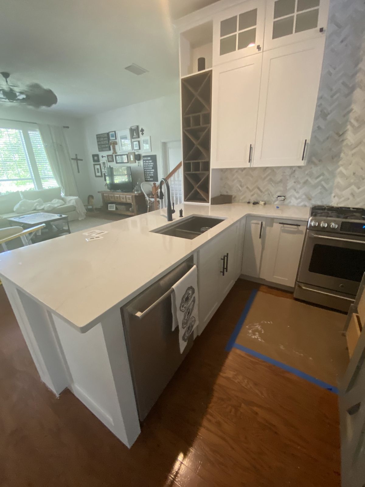 Finished white kitchen with island and shaker cabinets