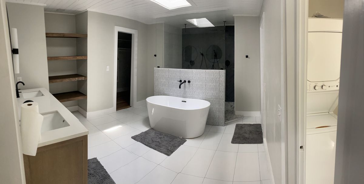 Bright white master bathroom with freestanding tub